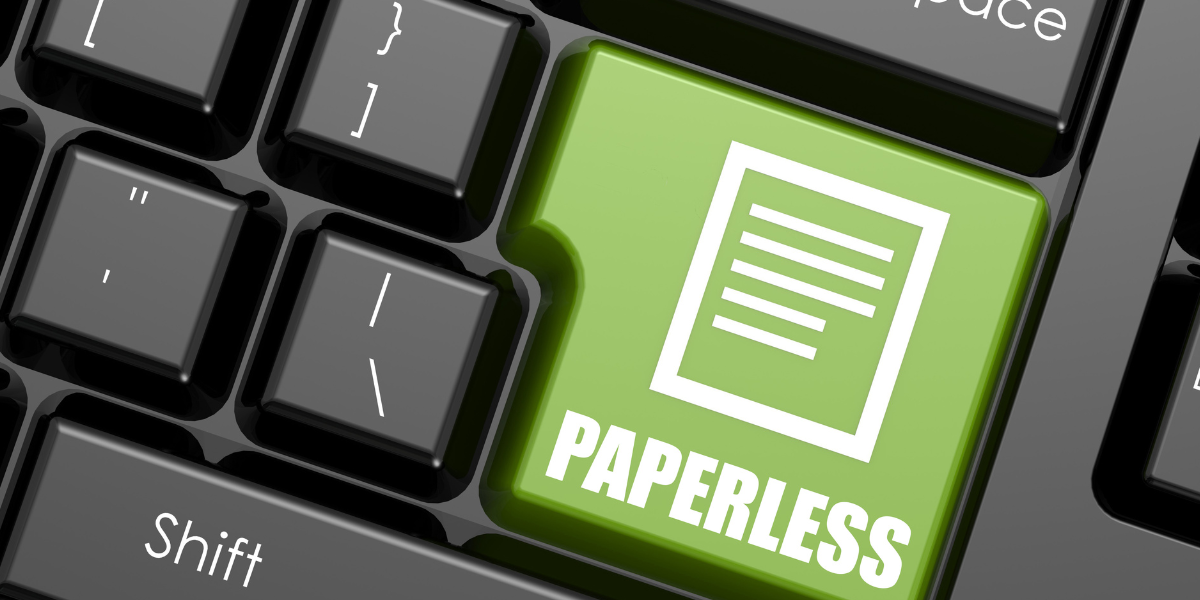 Nahaufnahme einer Computertastatur mit grüner 'Paperless'-Taste – Symbol für papierloses Arbeiten und digitale Dokumentenprozesse in Schweizer Unternehmen.